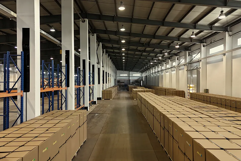 Warehouse aisle lined with packed cartons