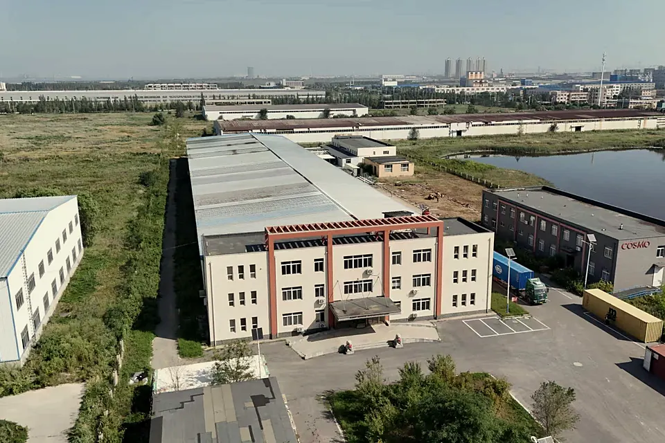 Aerial view of the factory buildings beside a pond