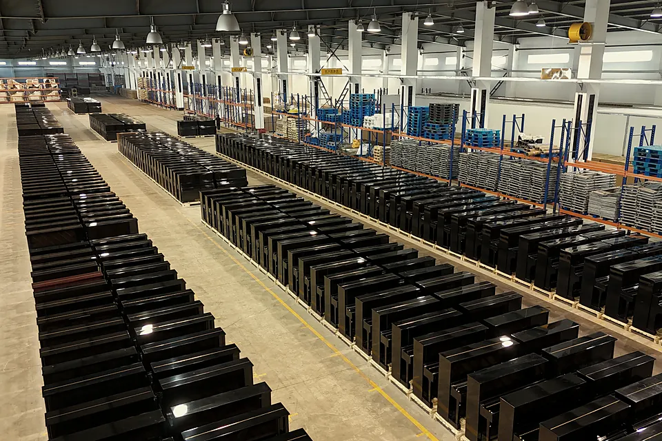 Rows of upright pianos in the warehouse